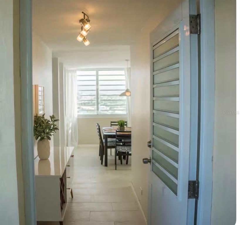 A view from a doorway into a dining area with a window and light fixture — 1610 PLAYA AZUL, TOWER 3 UNIT 1610, LUQUILLO, PR