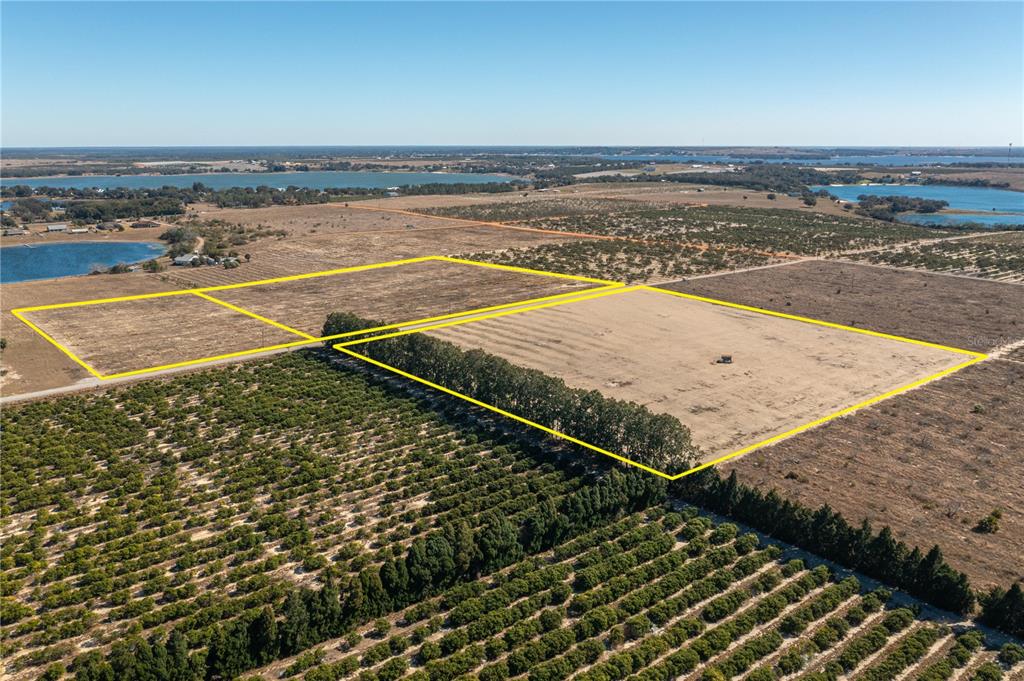 An aerial view shows several large, cleared rectangular plots of land bordered by trees and orchards — TOWNSEND ROAD, LAKE WALES, FL