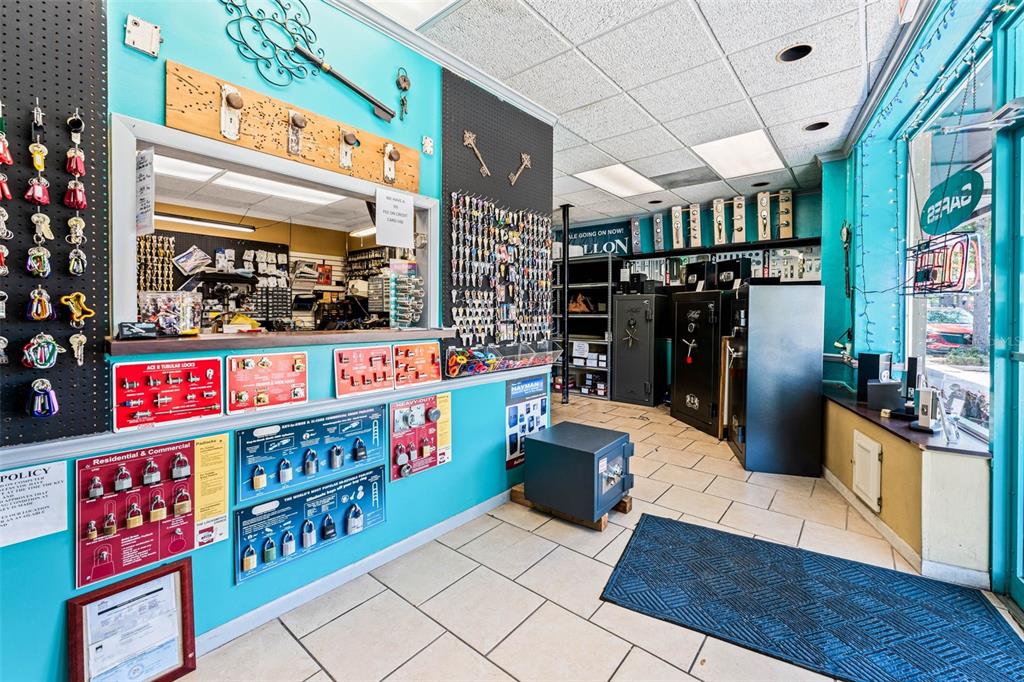 A locksmith shop interior features key displays, safes, and a service counter on tiled floors — 18 & 20 E PLANT STREET, WINTER GARDEN, FL
