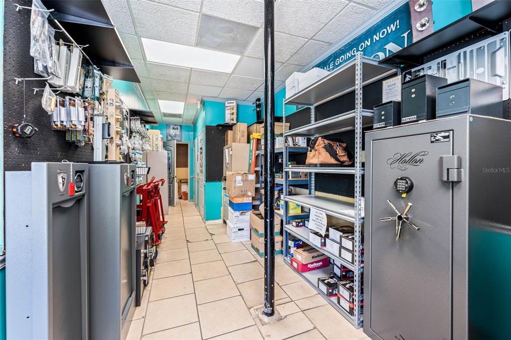 A commercial storage room features metal shelving units, safes, and various hardware supplies on display — 18 & 20 E PLANT STREET, WINTER GARDEN, FL