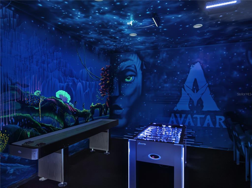 A themed game room features an Avatar mural, a shuffleboard table, and a foosball table — 7816 LOXAHATCHEE COURT, REUNION, FL
