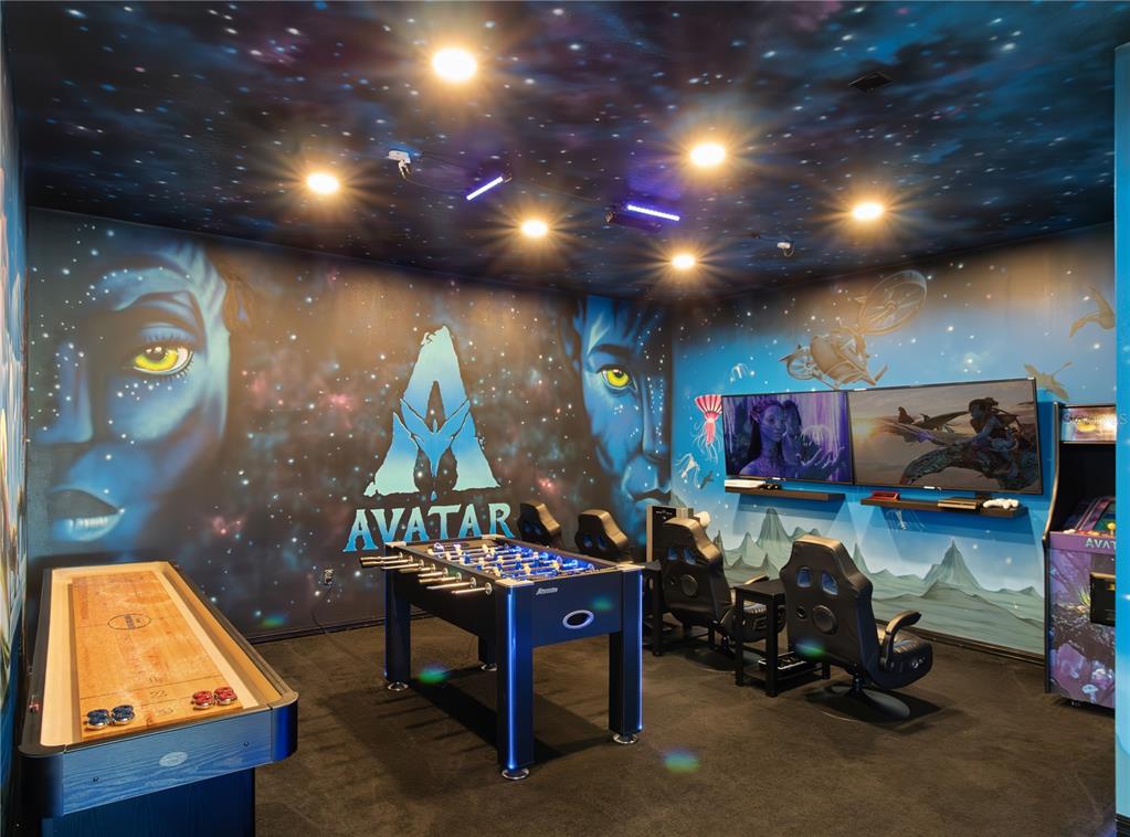 An Avatar-themed game room features a foosball table, shuffleboard table, gaming chairs, and wall murals — 7816 LOXAHATCHEE COURT, REUNION, FL