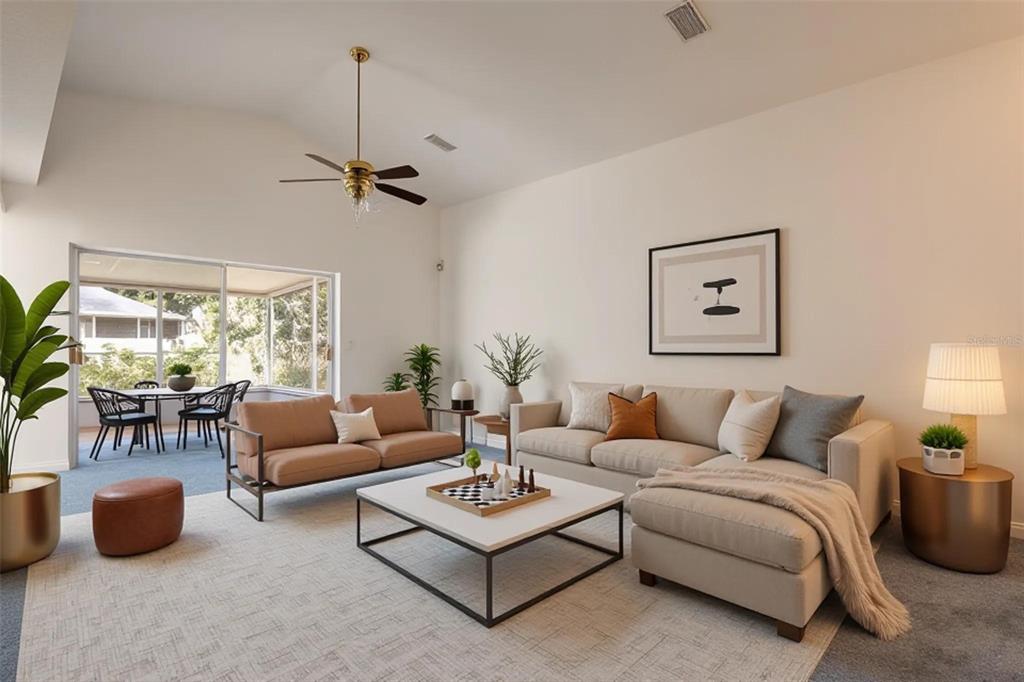 A living room features a beige sectional, a brown sofa, a coffee table, and a sunroom — 1914 WOODCUT DRIVE, LUTZ, FL