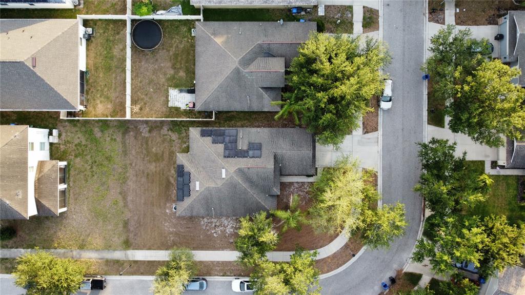 An aerial view shows two suburban houses with shingled roofs and solar panels — 7538 TURTLE VIEW DRIVE, SUN CITY CENTER, FL