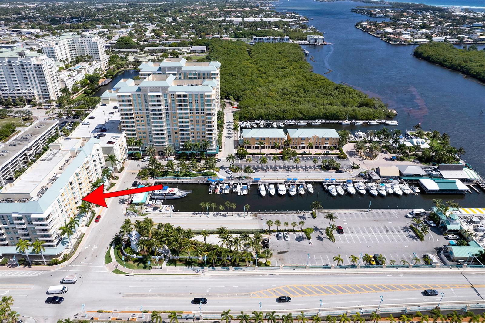 An aerial view shows a multi-story residential building with a red arrow pointing toward it — 100 NE 6th Street # 203, Boynton Beach FL 33435, BOYNTON BEACH, FL