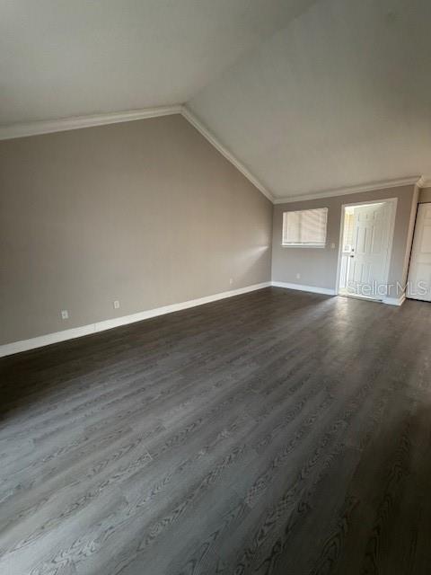 An empty room with vaulted ceilings, gray walls, and dark wood-look flooring — 7298 ULMERTON RD UNIT 611, LARGO, FL