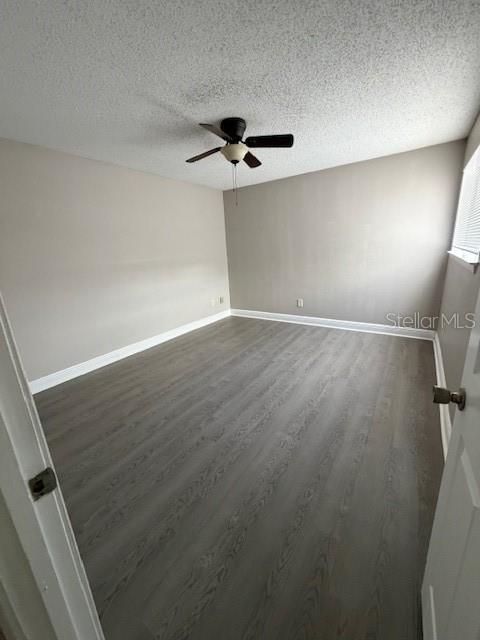 An empty bedroom features light gray walls, wood-look flooring, and a ceiling fan — 7298 ULMERTON RD UNIT 611, LARGO, FL