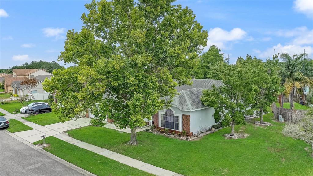 A single-story house with a gray roof and brick accents sits on a grassy lot — 2358 OLDFIELD DRIVE, ORLANDO, FL