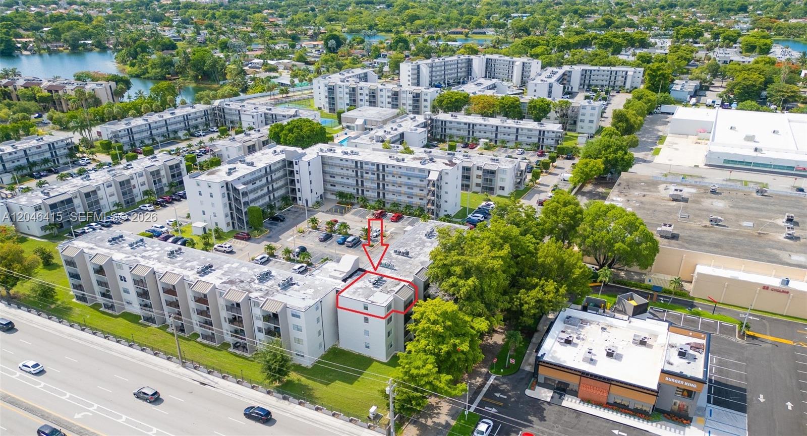 An aerial view shows a multi-story apartment complex with a highlighted unit and adjacent parking — 14155 SW 87th St, Miami FL 33183, MIAMI, FL