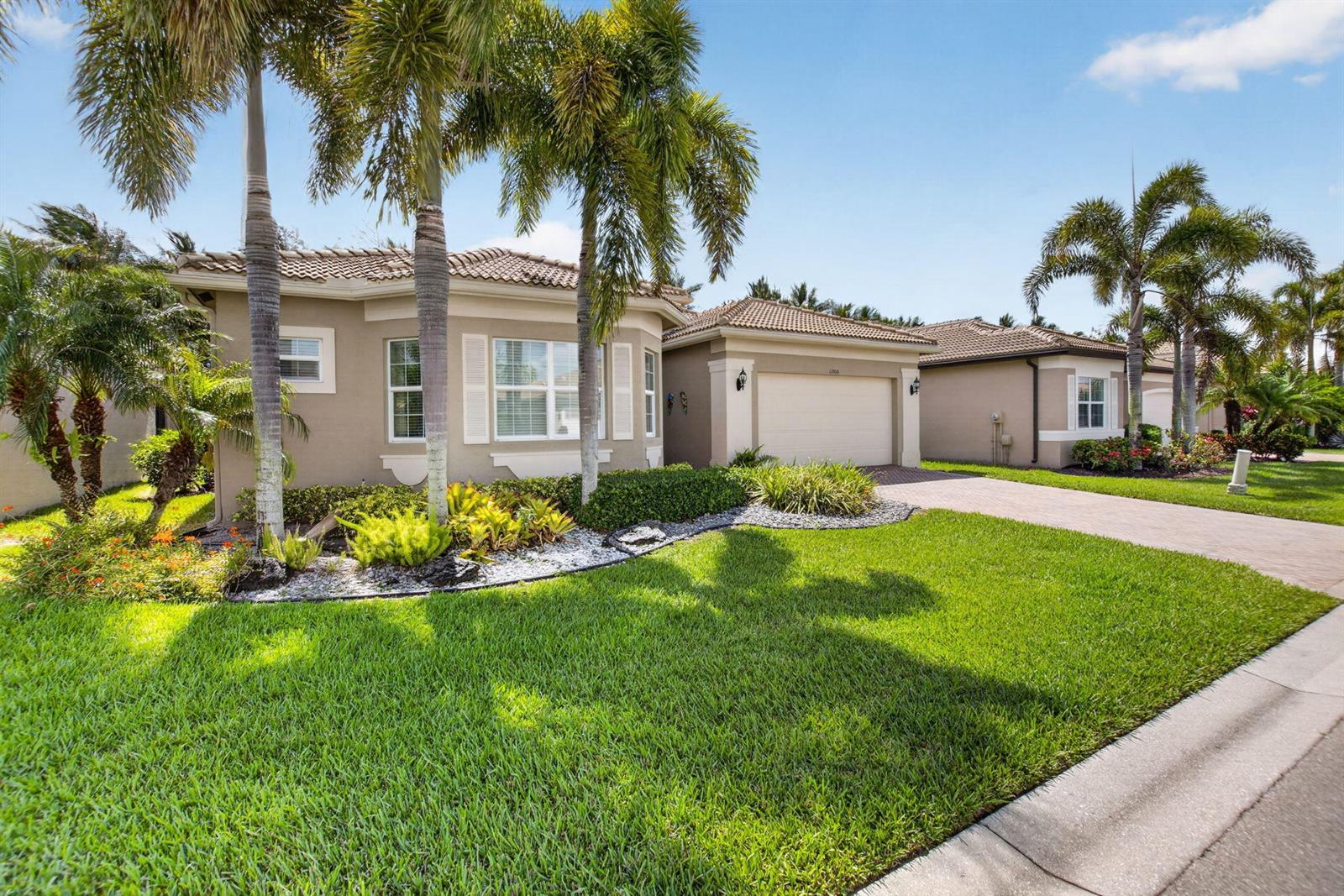 A single-story house with a tan stucco exterior, a tile roof, and a paved driveway — 11906 Catskill Commons Lane, Boynton Beach FL 33473, BOYNTON BEACH, FL