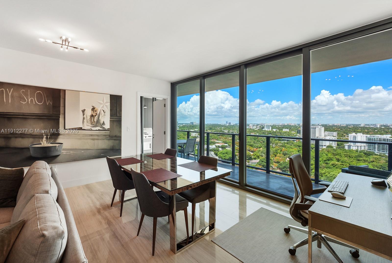 A dining and office area features a glass table, modern chairs, and floor-to-ceiling windows — 1451 Brickell Ave # 2405, Miami FL 33131, MIAMI, FL