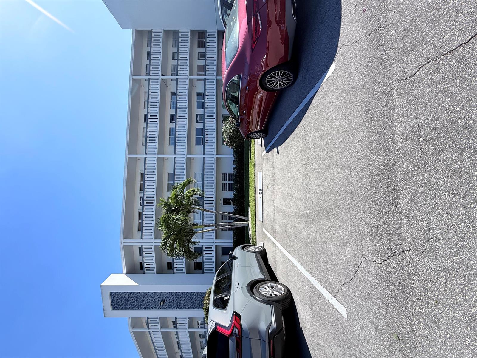 A multi-story apartment building with a parking lot in the foreground — 4108 Oakridge V # 4108, Deerfield Beach FL 33442, DEERFIELD BEACH, FL