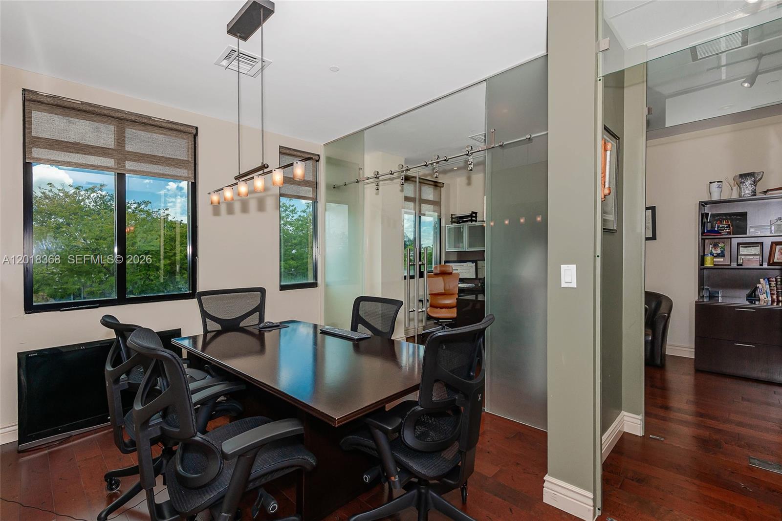 A conference room features a dark wood table, mesh office chairs, and glass sliding doors — 5599 S University Dr # 205, Davie FL 33328, DAVIE, FL