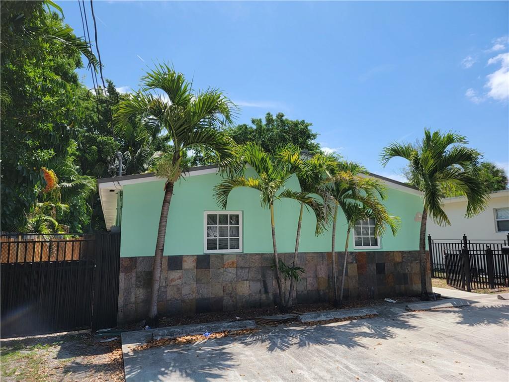 A light green building with a stone-tiled lower exterior and palm trees in front — 1010 NW 3rd Avenue, Hallandale Beach FL 33009, HALLANDALE BEACH, FL