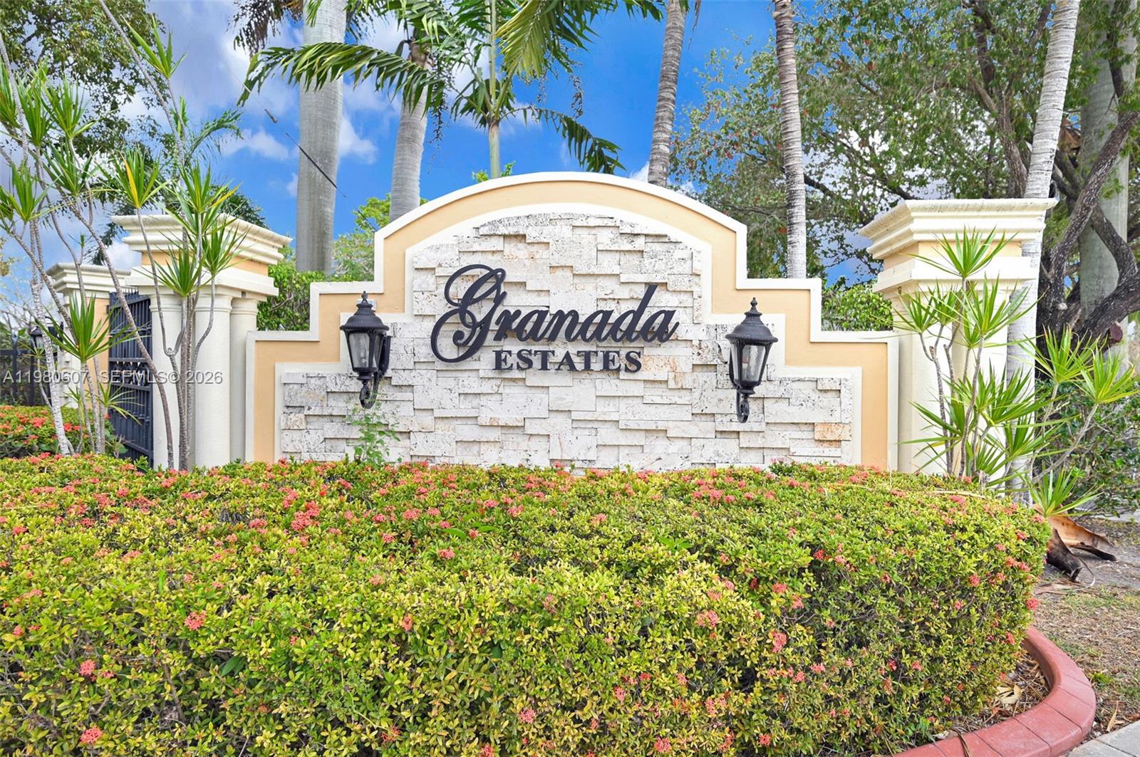 A front entrance features a brick walkway, a small gravel patio with two chairs, and a door — 2007 NE 6th Ct, Homestead FL 33033, HOMESTEAD, FL