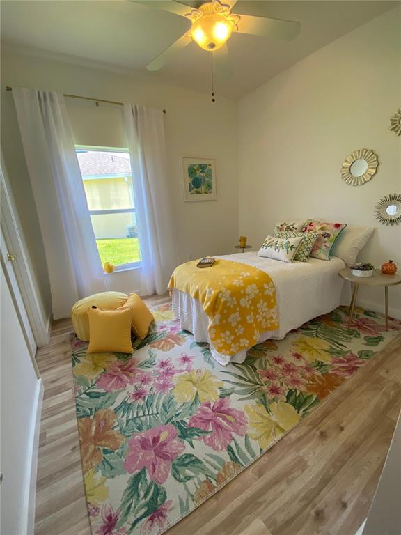 A bedroom features a floral area rug, a yellow throw blanket, and a ceiling fan — 176 CAPE FLORIDA DRIVE, KISSIMMEE, FL