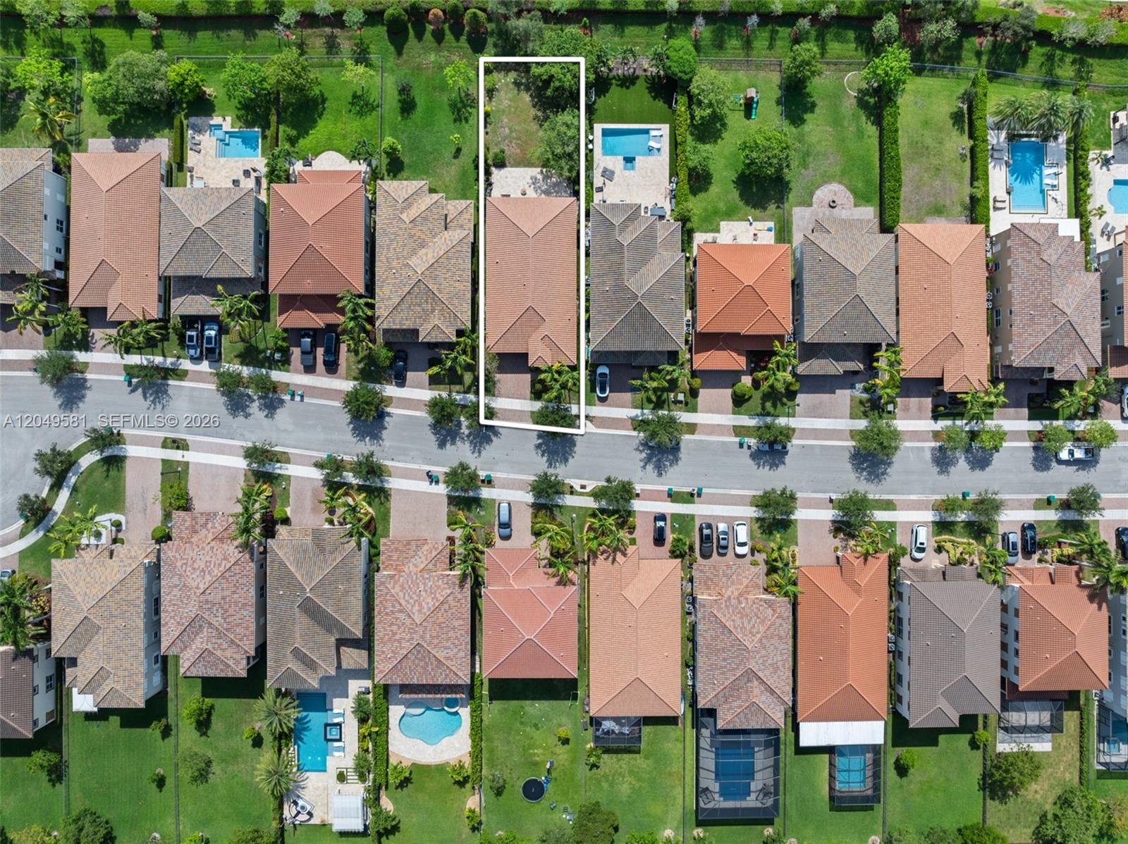 An aerial view shows a suburban residential street with houses, driveways, and backyards — 8530 Miralago Way, Parkland FL 33076, PARKLAND, FL