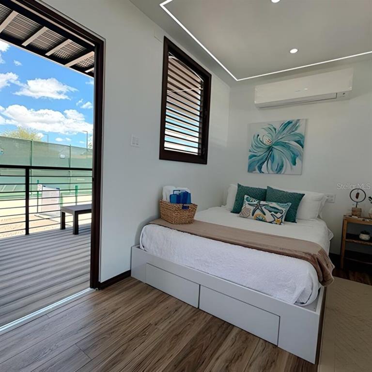 A bedroom with a bed, storage base, and a sliding door opening to a deck — SR 545 km 1.5 SECTOR GABIA HACIENDAS DEL SUR TENNIS CLUB, SANTA ISABEL, PR