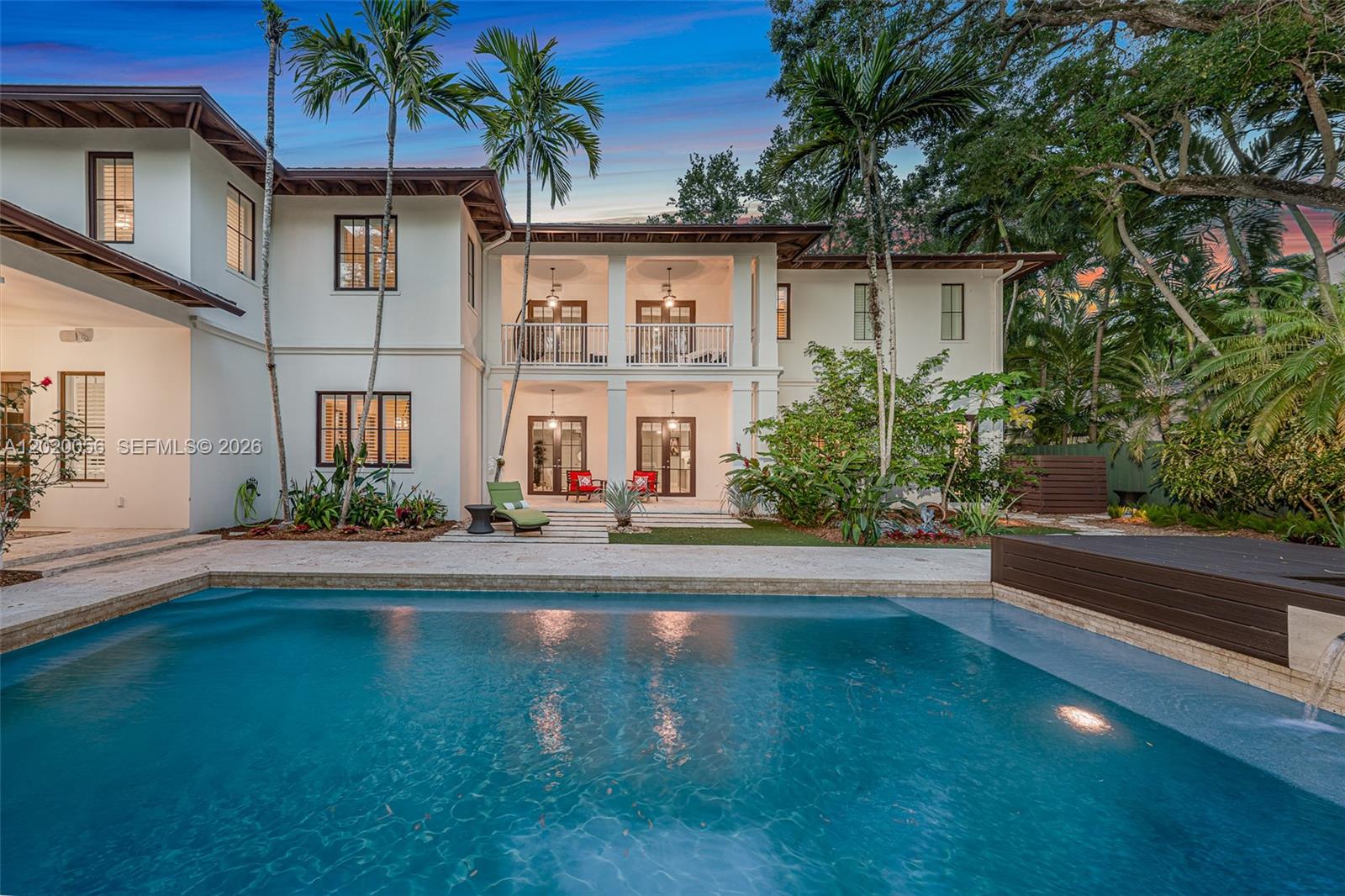A two-story white house with a pool, covered patio, and balcony overlooks a backyard — 4196 S Douglas Rd, Miami FL 33133, MIAMI, FL