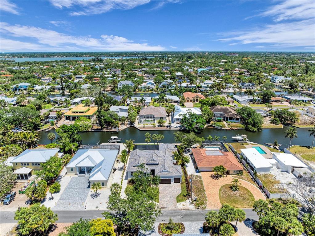 An aerial view shows waterfront houses with pools and docks along a canal in Florida — 5103 WINDWARD AVENUE, SARASOTA, FL