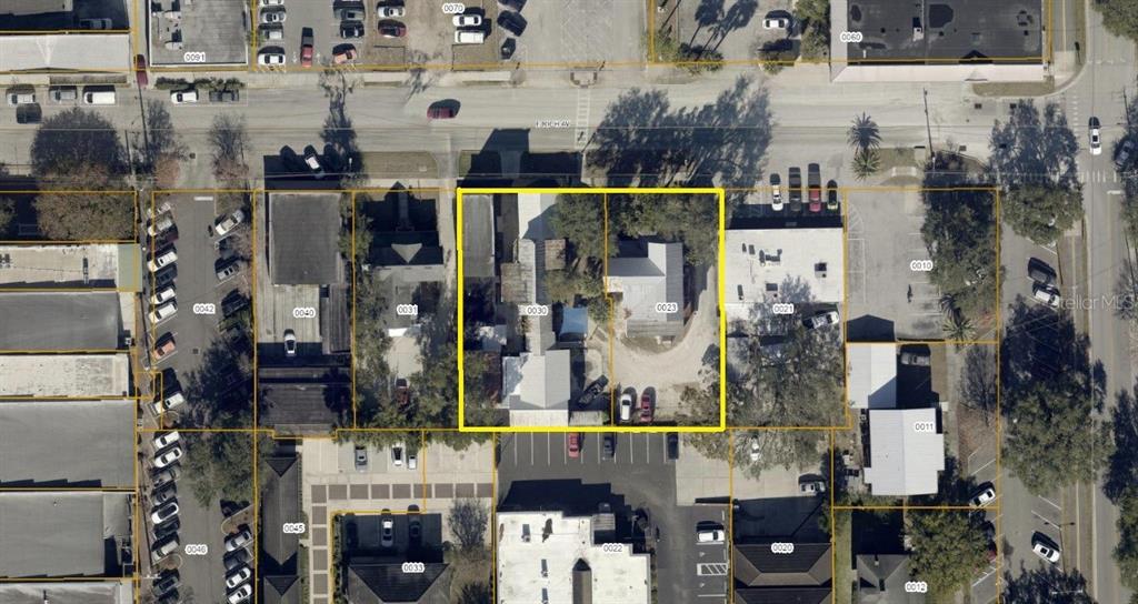 This aerial map shows two adjacent properties outlined in yellow within an urban neighborhood — 128 E RICH AVENUE, DELAND, FL