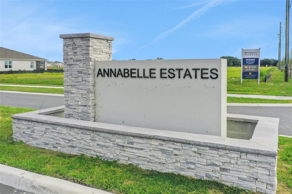 A stone-accented monument sign displays the name Annabelle Estates at a residential community entrance — 4097 PENELOPE AVENUE, LAKE WALES, FL