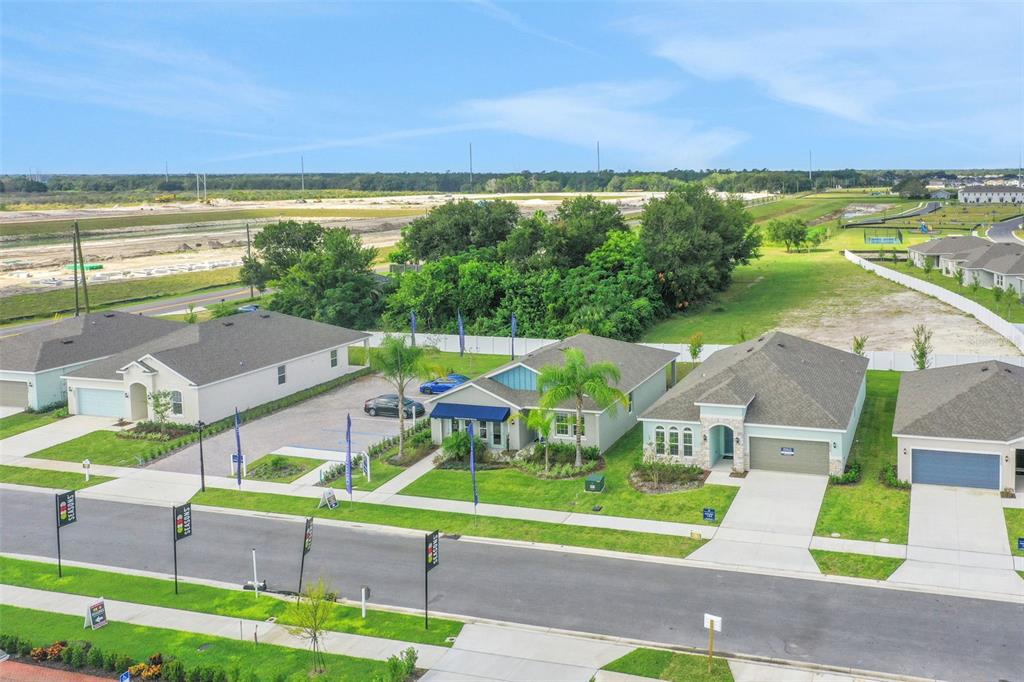 An aerial view shows a row of suburban houses with driveways and lawns along a street — 4097 PENELOPE AVENUE, LAKE WALES, FL