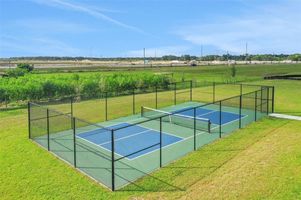 An outdoor pickleball court with a blue and green surface enclosed by a chain-link fence — 4097 PENELOPE AVENUE, LAKE WALES, FL