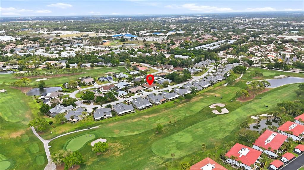 This aerial view shows a residential neighborhood situated along a golf course — 3508 AVENIDA MADERA, BRADENTON, FL
