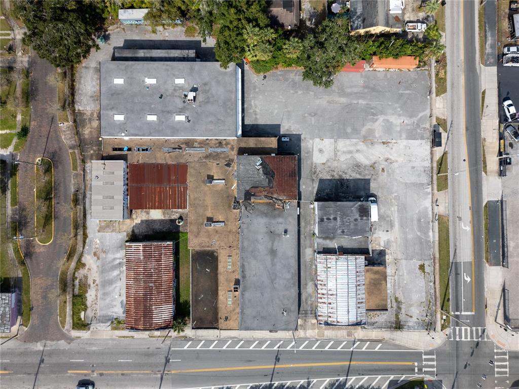 An aerial view shows a commercial property with multiple buildings and a large paved lot — 1011 W CENTRAL BOULEVARD, ORLANDO, FL