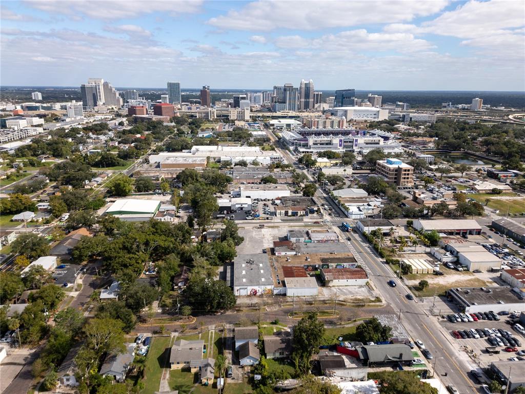 An aerial view shows a city skyline with surrounding industrial and residential buildings — 1011 W CENTRAL BOULEVARD, ORLANDO, FL