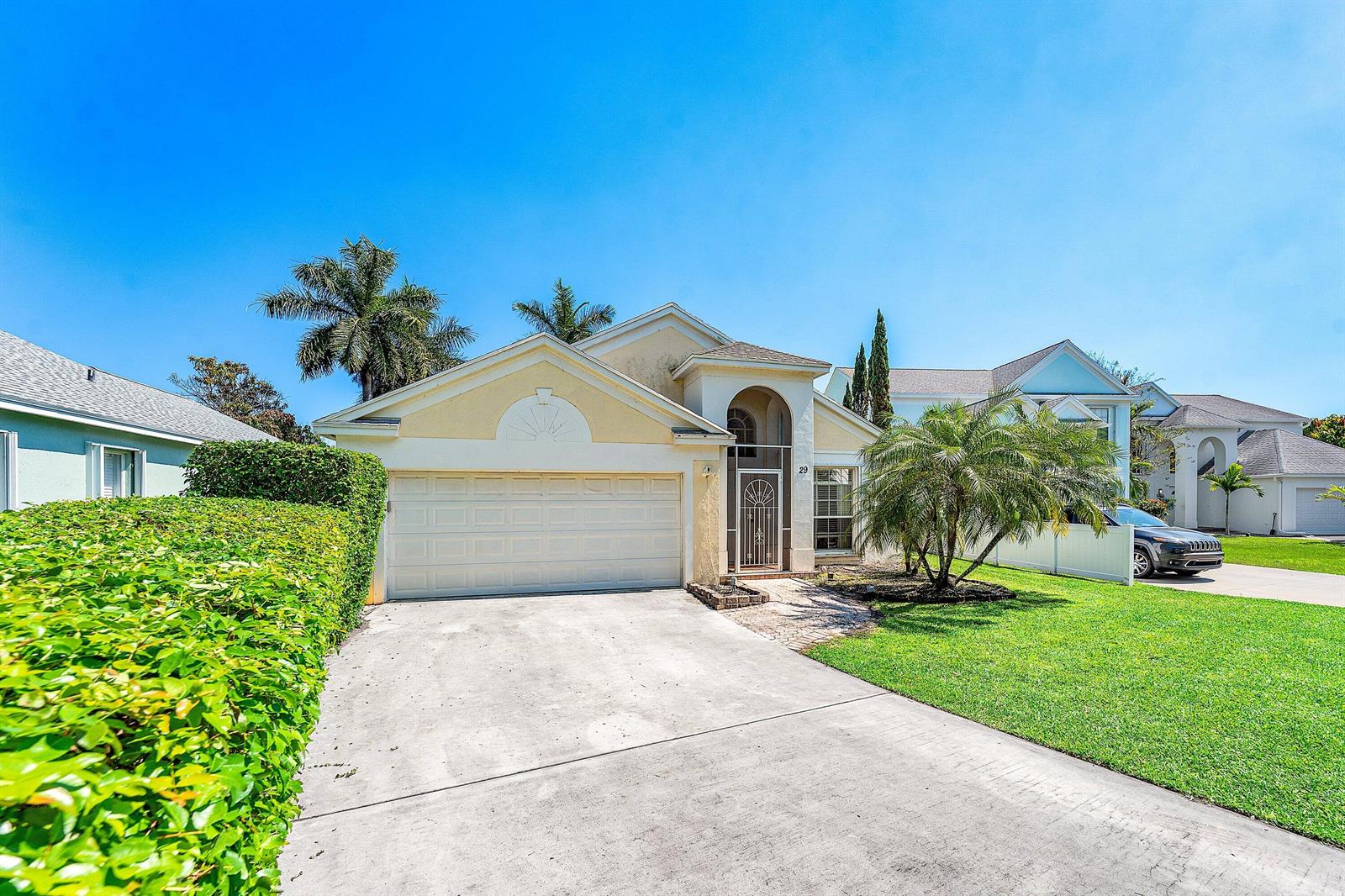 A single-story house with a two-car garage, a paved driveway, and a manicured front lawn — 29 Swallow Drive, Boynton Beach FL 33436, BOYNTON BEACH, FL