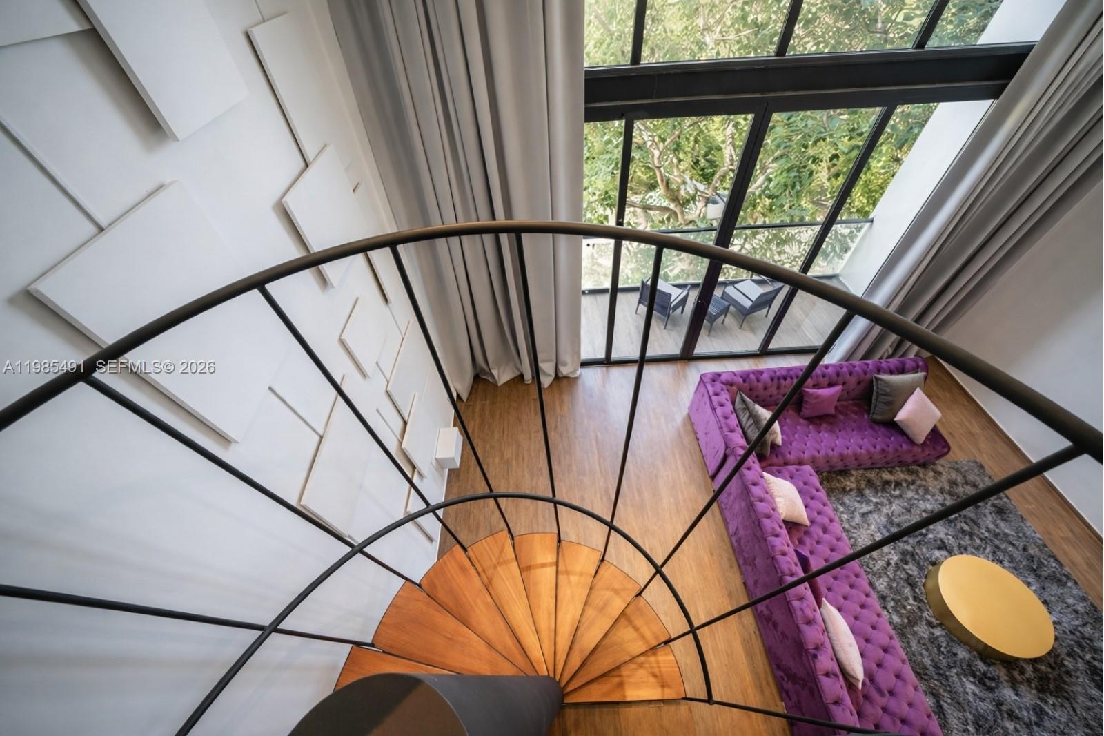 A high-angle view shows a spiral staircase overlooking a living room with a purple sofa — 0 Avenida CTM # 107, TX 77728, TX