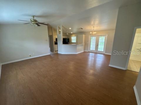 An open-concept living room with wood-look flooring, a ceiling fan, and a kitchen island — 2200 TOPSY TERRACE, NORTH PORT, FL