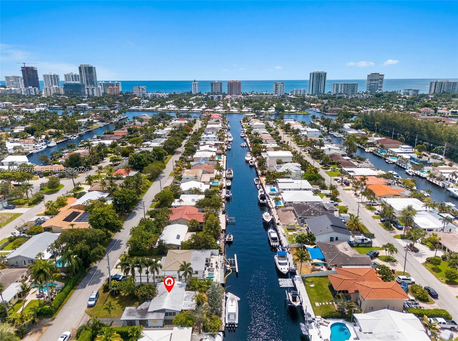 An aerial view shows a waterfront residential neighborhood with a canal and docked boats — 2472 SE 13th Ct, Pompano Beach FL 33062, POMPANO BEACH, FL