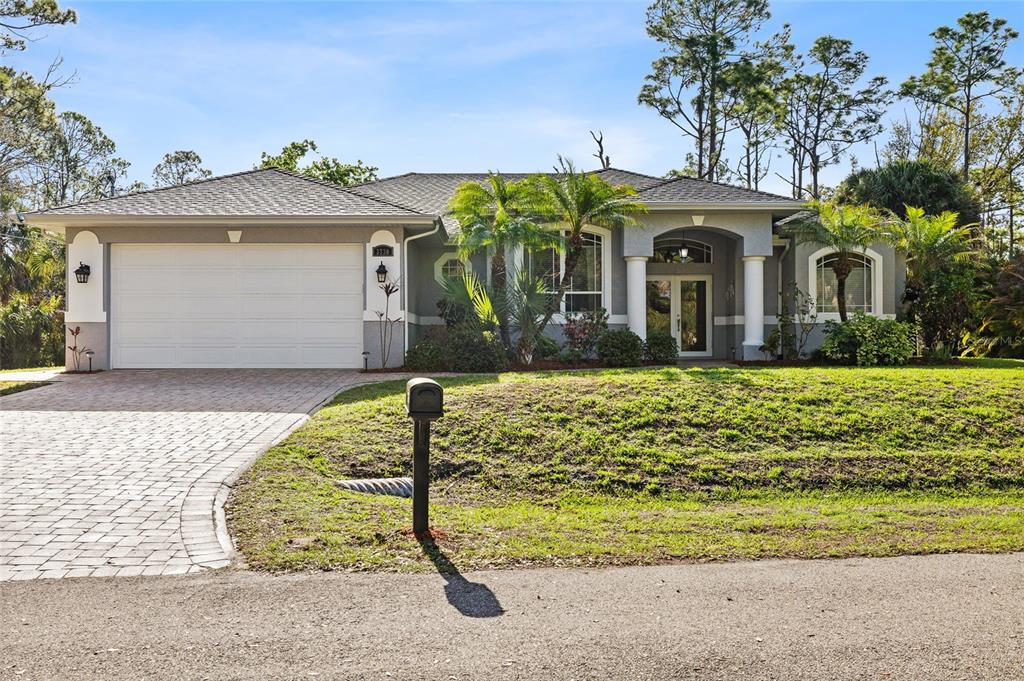 A single-story house with a two-car garage, a paved driveway, and a front lawn — 3730 CRANDON ROAD, NORTH PORT, FL