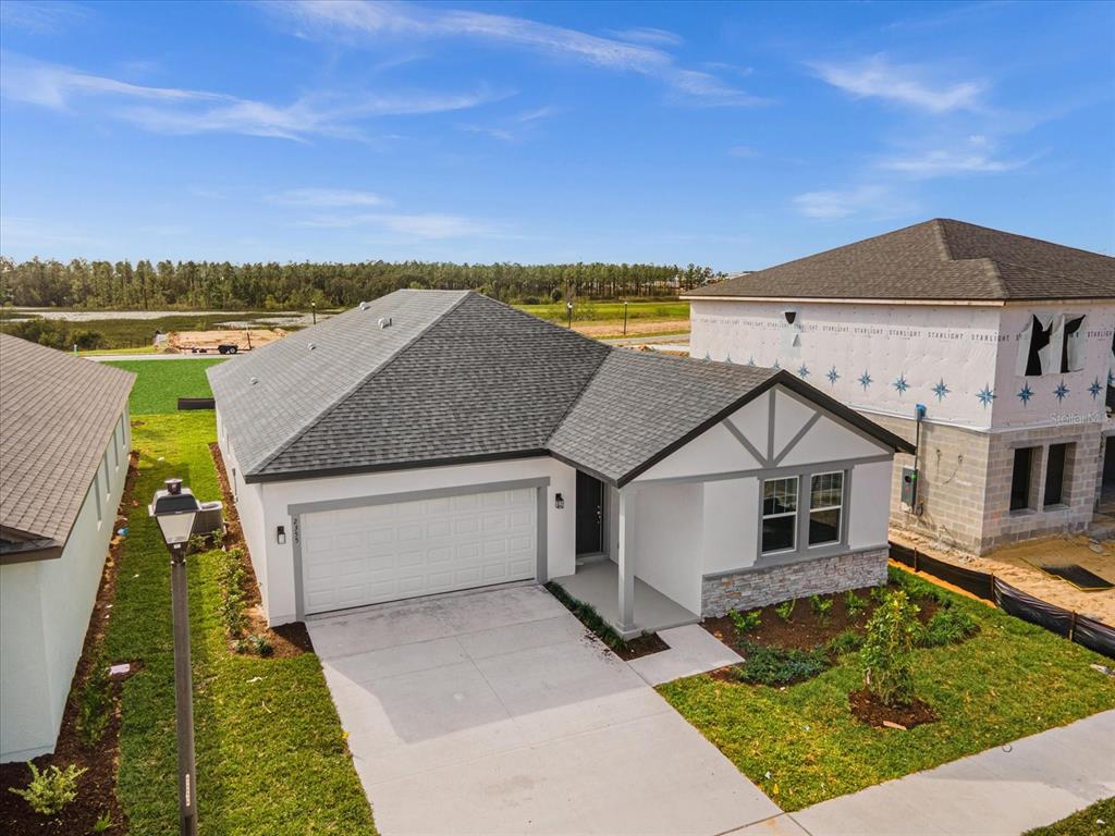 An aerial view of a single-story suburban house with a white exterior and gray roof — 2355 LANCASHIRE STREET, DAVENPORT, FL