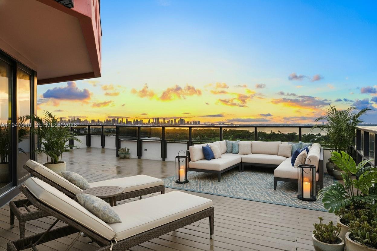 A spacious outdoor terrace features lounge chairs, a sectional sofa, and a panoramic city skyline view — 5225 Collins Ave, Miami Beach FL 33140, MIAMI BEACH, FL