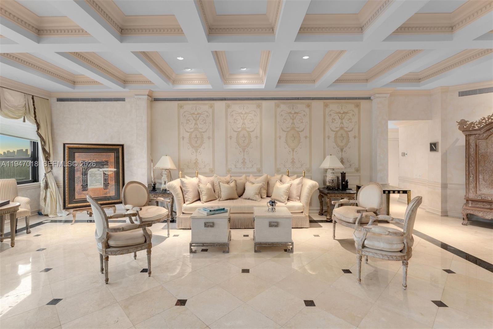 A formal living room features a coffered ceiling, marble floors, and ornate wall panels — 5225 Collins Ave, Miami Beach FL 33140, MIAMI BEACH, FL