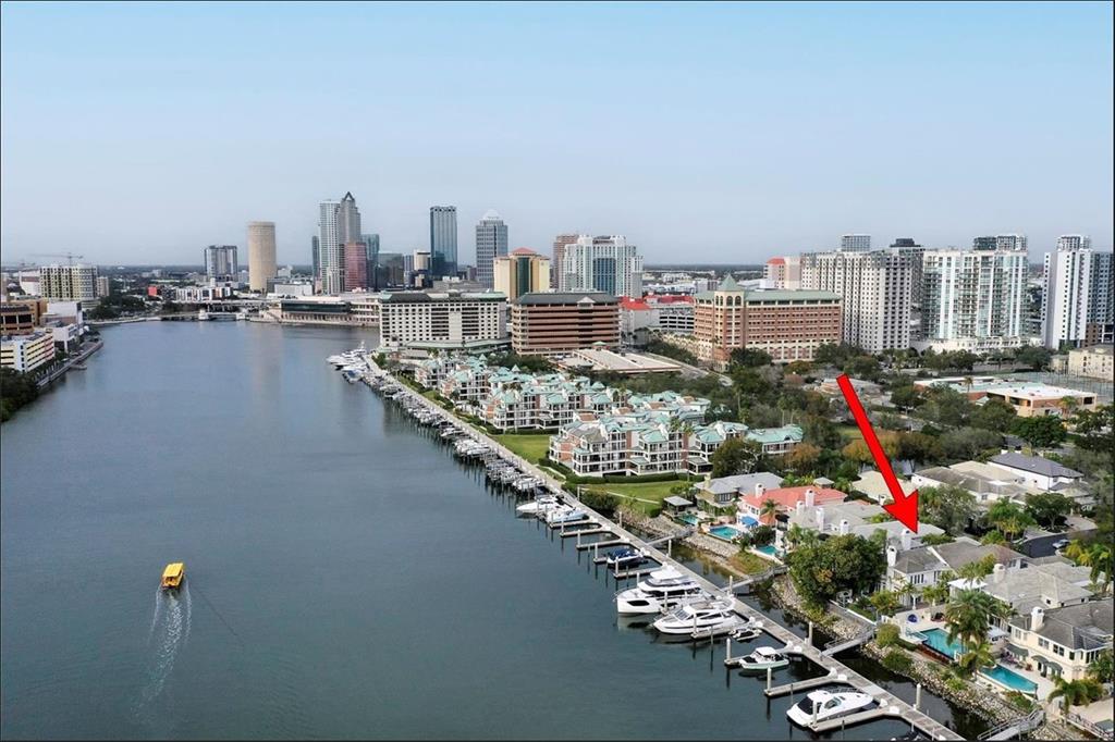 An aerial view of a waterfront house with a private dock and boat in Tampa — 60 MARINER WAY UNIT 60, TAMPA, FL
