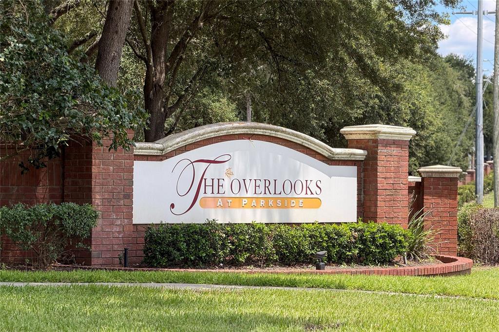 A brick monument sign displays the name The Overlooks at Parkside in a landscaped area — 494 ASHLEY BROOKE COURT UNIT A, APOPKA, FL