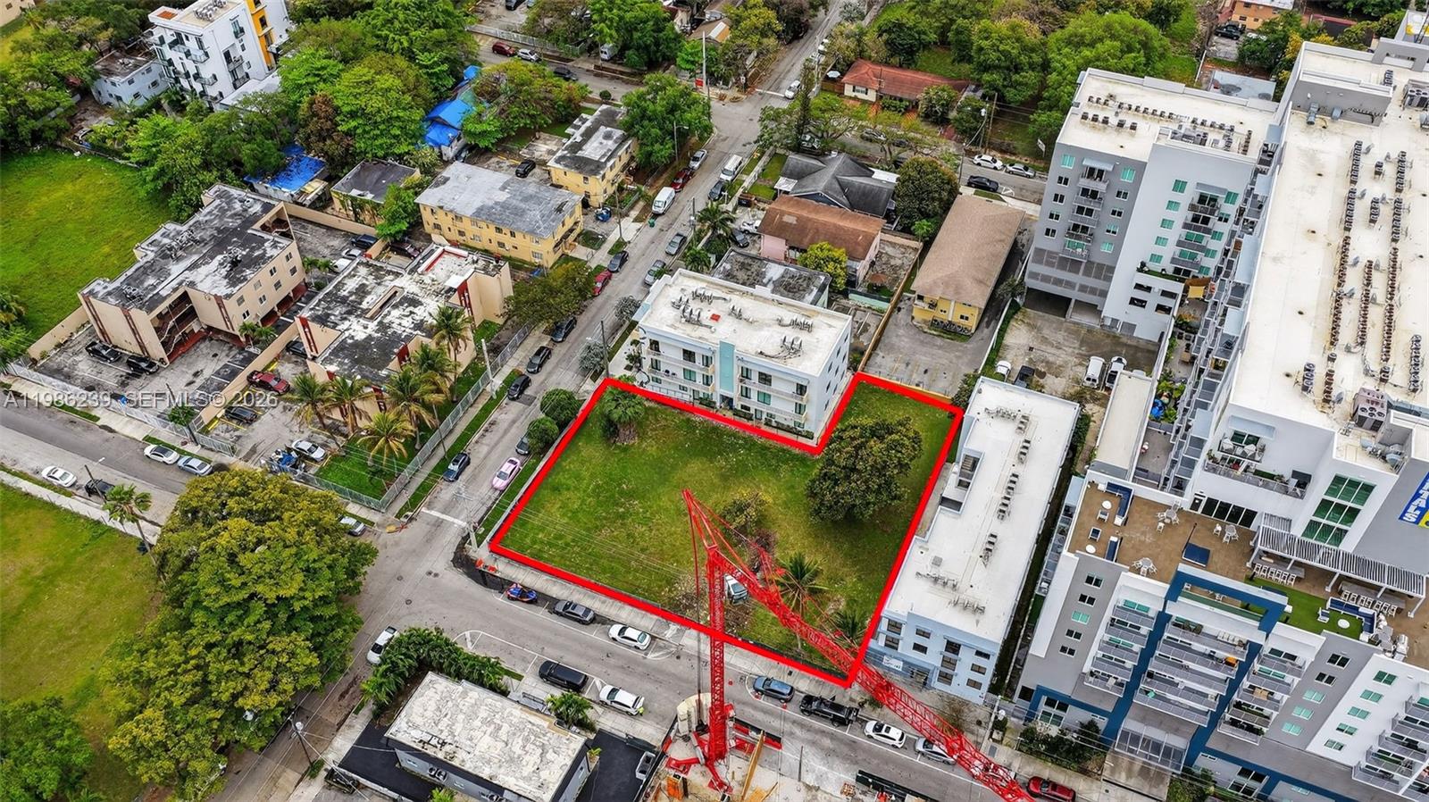 An aerial view shows a vacant rectangular lot outlined in red within a city neighborhood — 244 NW 7th Ave, Miami FL 33128, MIAMI, FL
