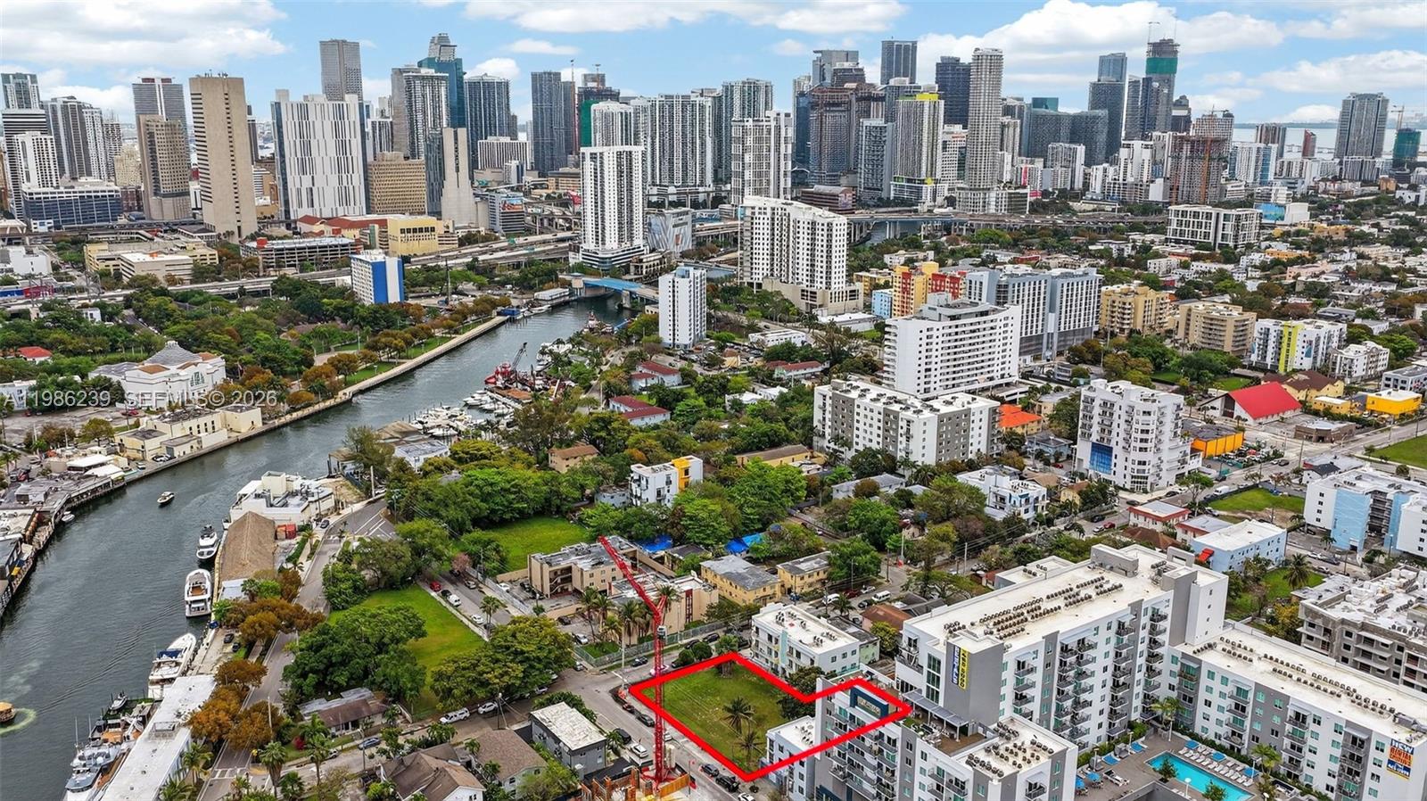 An aerial view shows a vacant rectangular lot outlined in red within a city neighborhood — 244 NW 7th Ave, Miami FL 33128, MIAMI, FL