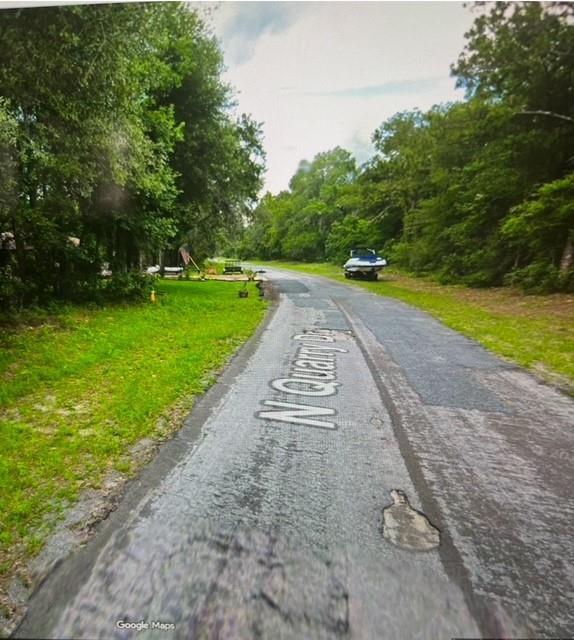 A paved road named N Quarry Dr winds through a wooded area with a parked boat — 9550 N Quarry Drive, FL 34434, FL