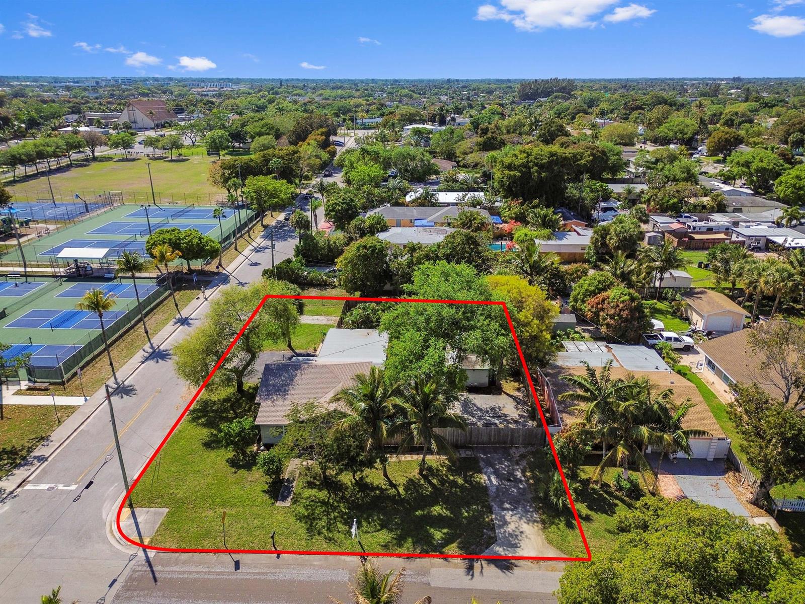 An aerial view shows a single-story house with a large yard outlined in red — 1501 N D Street, FL 33460, FL