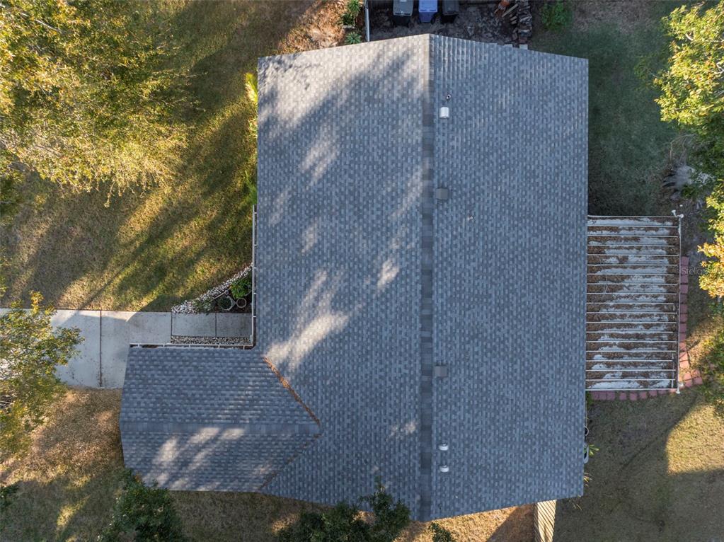 An aerial view shows the shingled roof of a house with a small attached patio — 11305 SILVERLEAF COURT, RIVERVIEW, FL