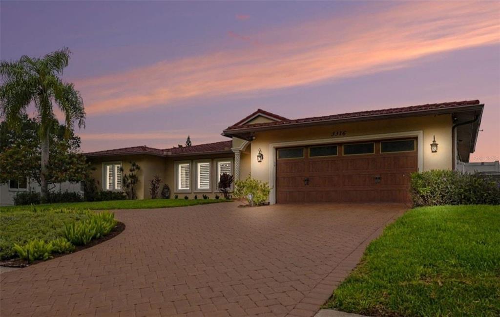 A single-story house with a paved driveway, a two-car garage, and a tile roof — 3316 SAN JOSE STREET, CLEARWATER, FL