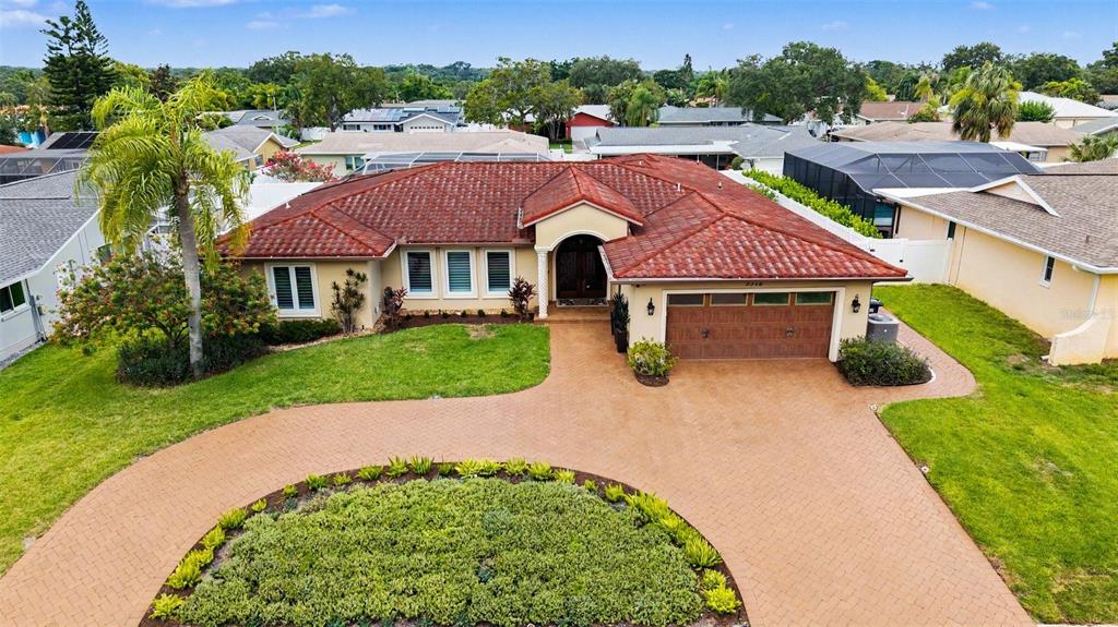 An aerial view of a single-story house with a red tile roof and paved driveway — 3316 SAN JOSE STREET, CLEARWATER, FL