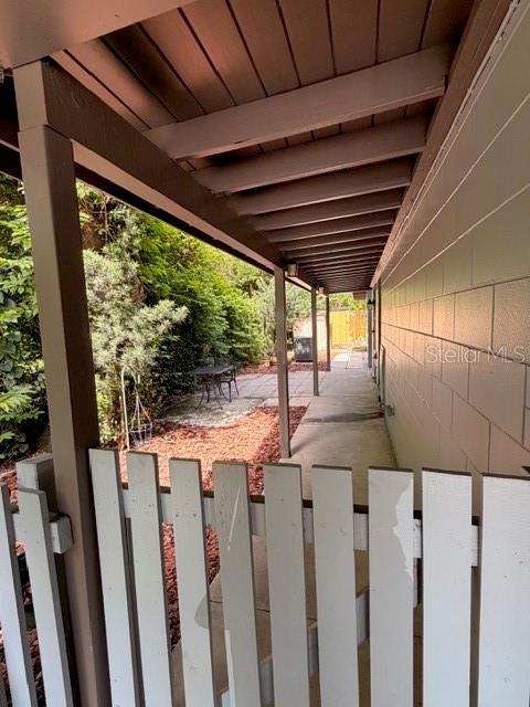 A light blue house exterior features a large arched carport and a concrete driveway — 250 CEDARWOOD DRIVE, MAITLAND, FL