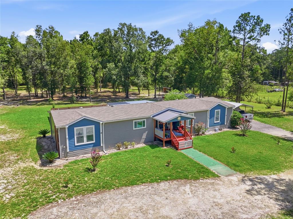 An aerial view of a gray manufactured home with blue accents and a front porch — 12185 198TH TERRACE, O'BRIEN, FL